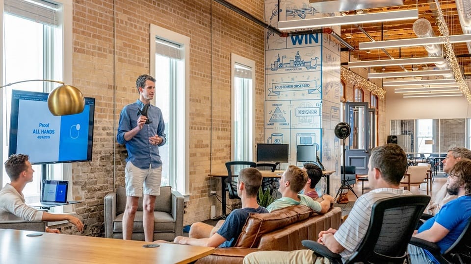 A conference audience facing a speaker